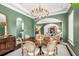 Formal dining room with a large chandelier and elegant furnishings at 1000 Via Tuscany Oaks Way, Winter Park, FL 32789