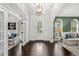 Bright entryway with dark hardwood floors, high ceilings, and views into adjacent rooms at 1000 Via Tuscany Oaks Way, Winter Park, FL 32789