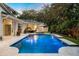 Stunning pool and patio area with outdoor kitchen and lounge seating at 1000 Via Tuscany Oaks Way, Winter Park, FL 32789