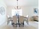 Modern farmhouse dining room with a large window at 1028 Cinnamon Fern Ct, Casselberry, FL 32707