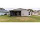 Rear view of house showing screened patio and lawn at 1028 Cinnamon Fern Ct, Casselberry, FL 32707