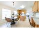 Bright kitchen with wood cabinets, island, and dining area at 1028 Cinnamon Fern Ct, Casselberry, FL 32707