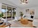 Living room features a sliding glass door to screened patio and neutral decor at 1028 Cinnamon Fern Ct, Casselberry, FL 32707