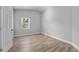 Spacious bedroom featuring light grey walls and wood-look floors at 1058 Florida Holly Dr, Orlando, FL 32811