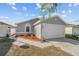 House exterior with a white garage door and landscaping at 1058 Florida Holly Dr, Orlando, FL 32811