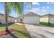 House exterior with a white garage door and landscaping at 1058 Florida Holly Dr, Orlando, FL 32811