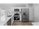 Stainless steel appliances and white shaker cabinets in kitchen at 1058 Florida Holly Dr, Orlando, FL 32811