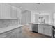 Modern kitchen with island and stainless steel dishwasher at 1058 Florida Holly Dr, Orlando, FL 32811