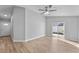 Living room with vinyl plank flooring and sliding glass doors to backyard at 1058 Florida Holly Dr, Orlando, FL 32811