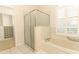 Bathroom with shower, tub, and walk-in closet at 11537 Blackmoor Dr, Orlando, FL 32837