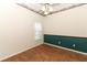 Bedroom with wood-look floors and green accent wall at 11537 Blackmoor Dr, Orlando, FL 32837