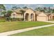 Tan house with a two-car garage and palm trees at 11537 Blackmoor Dr, Orlando, FL 32837