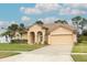 Tan house with a two-car garage and palm trees at 11537 Blackmoor Dr, Orlando, FL 32837