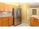 Kitchen with stainless steel refrigerator and wood cabinets at 11537 Blackmoor Dr, Orlando, FL 32837