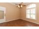 Living room with wood floors, ceiling fan, and large window with blinds at 11537 Blackmoor Dr, Orlando, FL 32837