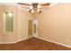 Living room with wood floors, ceiling fan, and built-in shelving at 11537 Blackmoor Dr, Orlando, FL 32837