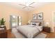 Main bedroom with wood-look floors, sliding doors to pool area, and ceiling fan at 11537 Blackmoor Dr, Orlando, FL 32837