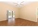 Main bedroom with wood-look floors and sliding glass doors to the pool at 11537 Blackmoor Dr, Orlando, FL 32837