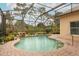 Kidney shaped pool with waterfall feature and screened enclosure at 11537 Blackmoor Dr, Orlando, FL 32837