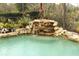 Artificial waterfall feature in a screened pool area at 11537 Blackmoor Dr, Orlando, FL 32837