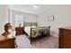 Guest bedroom with a metal bed frame and wood nightstand at 11769 Hampstead St, Windermere, FL 34786