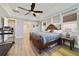 Main bedroom with a king-size bed and hardwood floors at 11769 Hampstead St, Windermere, FL 34786