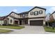 Two-story house with stone accents and a three-car garage at 11769 Hampstead St, Windermere, FL 34786