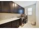 Laundry room with dark brown cabinets and washer/dryer at 11769 Hampstead St, Windermere, FL 34786