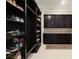 Large walk-in shoe closet with dark brown shelving at 11769 Hampstead St, Windermere, FL 34786