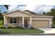 One-story home with stone accents and a two-car garage at 1214 Normandy Dr, Haines City, FL 33844