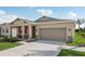 House exterior showcasing a two-car garage and walkway at 1214 Normandy Dr, Haines City, FL 33844