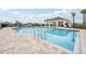 Community pool with a large deck and lounge chairs at 1214 Normandy Dr, Haines City, FL 33844