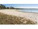 Lakefront sandy beach with grassy areas at 1214 Normandy Dr, Haines City, FL 33844