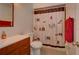 Bathroom with a shower/tub combo, wood vanity, and updated fixtures at 1220 Alden Ter, Deltona, FL 32738