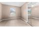 Bedroom with light pink walls, wood floors and mirrored closet at 1220 Alden Ter, Deltona, FL 32738