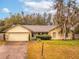 House exterior features a two-car garage and landscaping at 1220 Alden Ter, Deltona, FL 32738