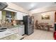 Kitchen with stainless steel fridge and adjacent dining area at 1220 Alden Ter, Deltona, FL 32738