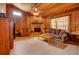 Living room with stone fireplace, wood paneled walls, and hardwood floors at 1220 Alden Ter, Deltona, FL 32738