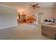 Bright living room with hardwood floors, a piano, and access to dining area at 1220 Alden Ter, Deltona, FL 32738