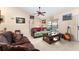 Living room with leather couches, wood floor, and large window at 1220 Alden Ter, Deltona, FL 32738