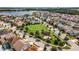 Aerial view of a Gathering friendly community with green spaces, playgrounds and lake views at 14190 Dove Hollow Dr, Orlando, FL 32824