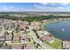 An aerial view of a community showing lakefront properties, community pool, and well-maintained landscaping at 14190 Dove Hollow Dr, Orlando, FL 32824