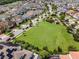 An aerial shot showcases a sprawling lawn and playground, highlighting community green space at 14190 Dove Hollow Dr, Orlando, FL 32824