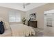 Well-lit bedroom with a ceiling fan, neutral decor, and view into a walk-in closet at 14190 Dove Hollow Dr, Orlando, FL 32824