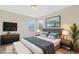 This staged bedroom features a modern design, wall-mounted TV, and matching nightstands at 14190 Dove Hollow Dr, Orlando, FL 32824