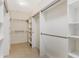 Spacious walk-in closet with built-in shelving and hanging rods at 14190 Dove Hollow Dr, Orlando, FL 32824