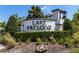 An inviting community entrance sign surrounded by lush greenery and landscaping at 14190 Dove Hollow Dr, Orlando, FL 32824