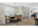 Inviting dining area filled with natural light, modern light fixture and neutral color palette at 14190 Dove Hollow Dr, Orlando, FL 32824