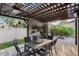 Delightful patio area with brick pavers, a pergola, and a cozy outdoor dining space surrounded by lush greenery at 14190 Dove Hollow Dr, Orlando, FL 32824