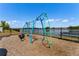 A community playground featuring swings, rope ladders, and lake views providing a fun space for children at 14190 Dove Hollow Dr, Orlando, FL 32824